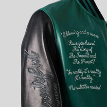 Green and black sleeve with embroidered text on a gray background