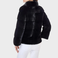 Black fur jacket worn by a person on a white background