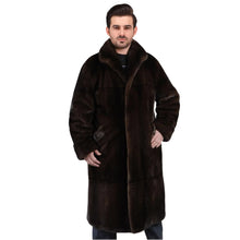 Man wearing a long brown fur coat on a white background