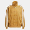 Yellow jacket with white stripes and Adidas logo on a light gray background