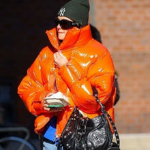 Dua Lipa bright orange puffer jacket