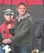 Model wearing Clayface 2026 movie green cotton jacket over a hoodie