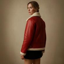 Woman wearing a red leather jacket with white fur lining on a beige background